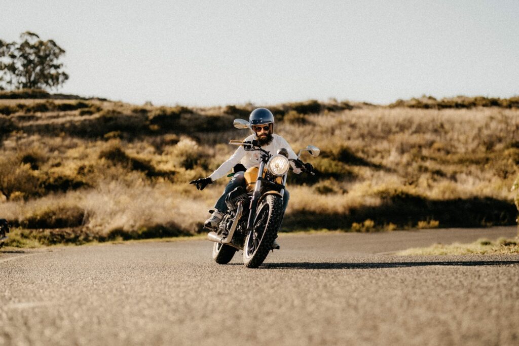 a man riding a motorcycle down a curvy road