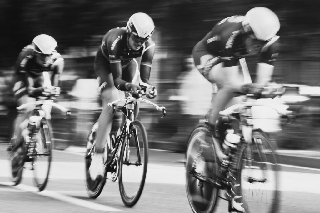 time lapse photography of three men cycling